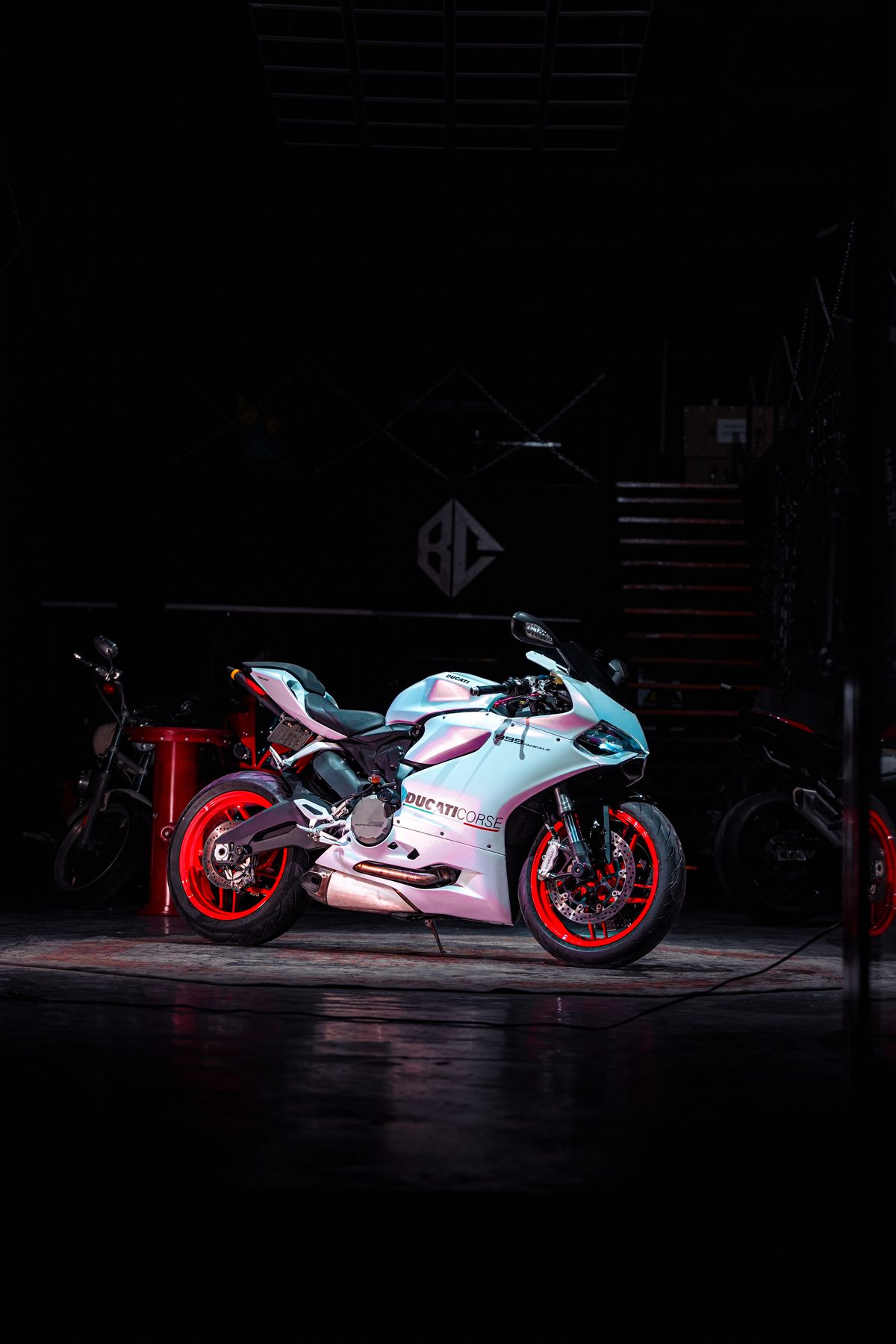 White and red sportbike in dark studio lighting